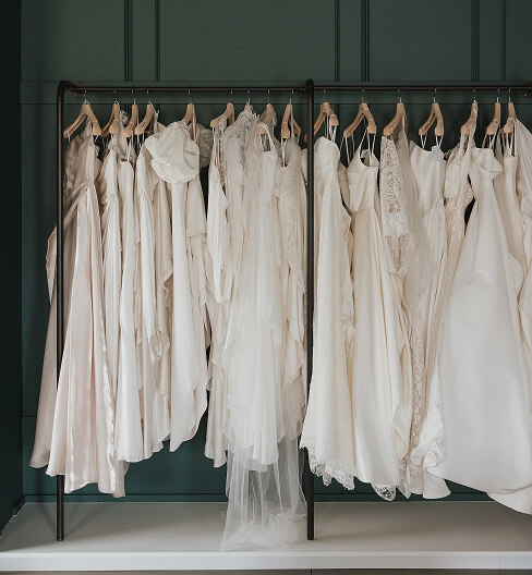 Wedding dresses hanging in a bridal boutique